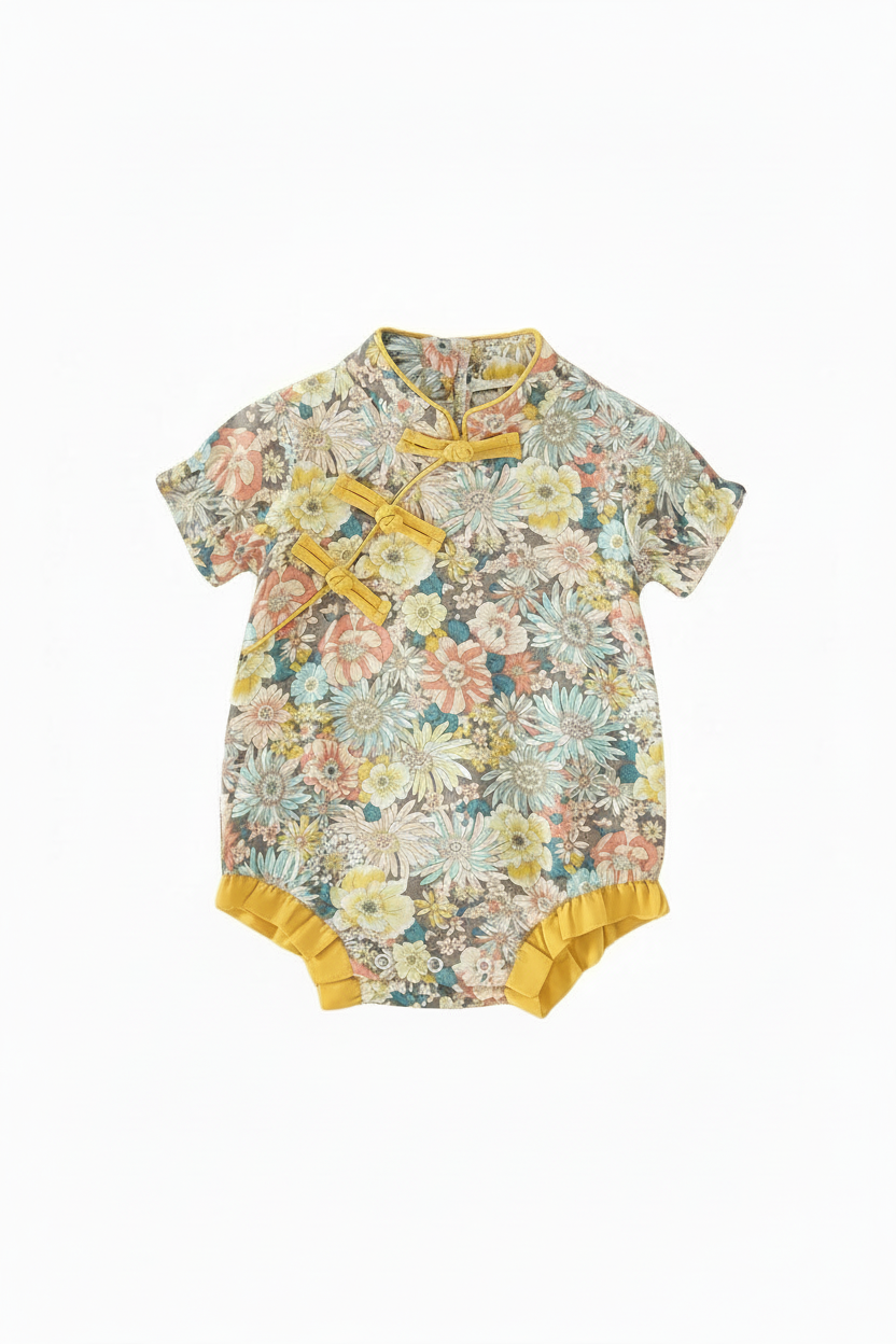 Floral romper with mustard fasteners and cuffs